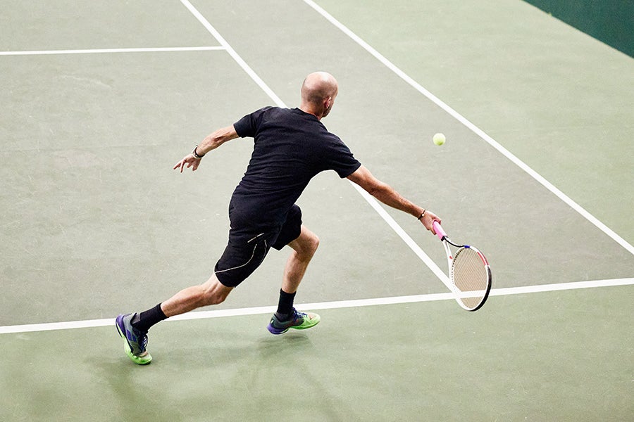 Wide fitting tennis shoes with room for toes to spread on astro turf