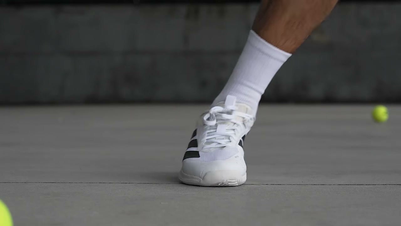 adidas court shoe biting into a hard court surface during a rally