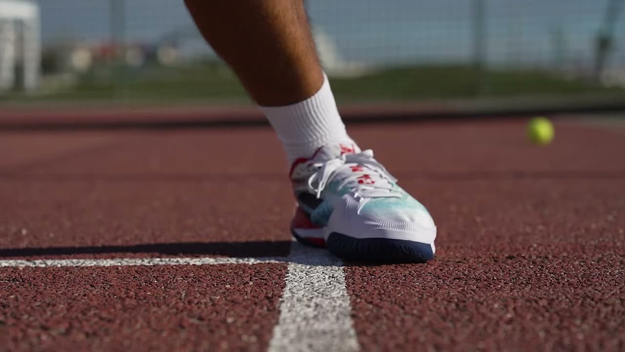 Babolat court shoe stretched across the forefoot in a wide defensive stance