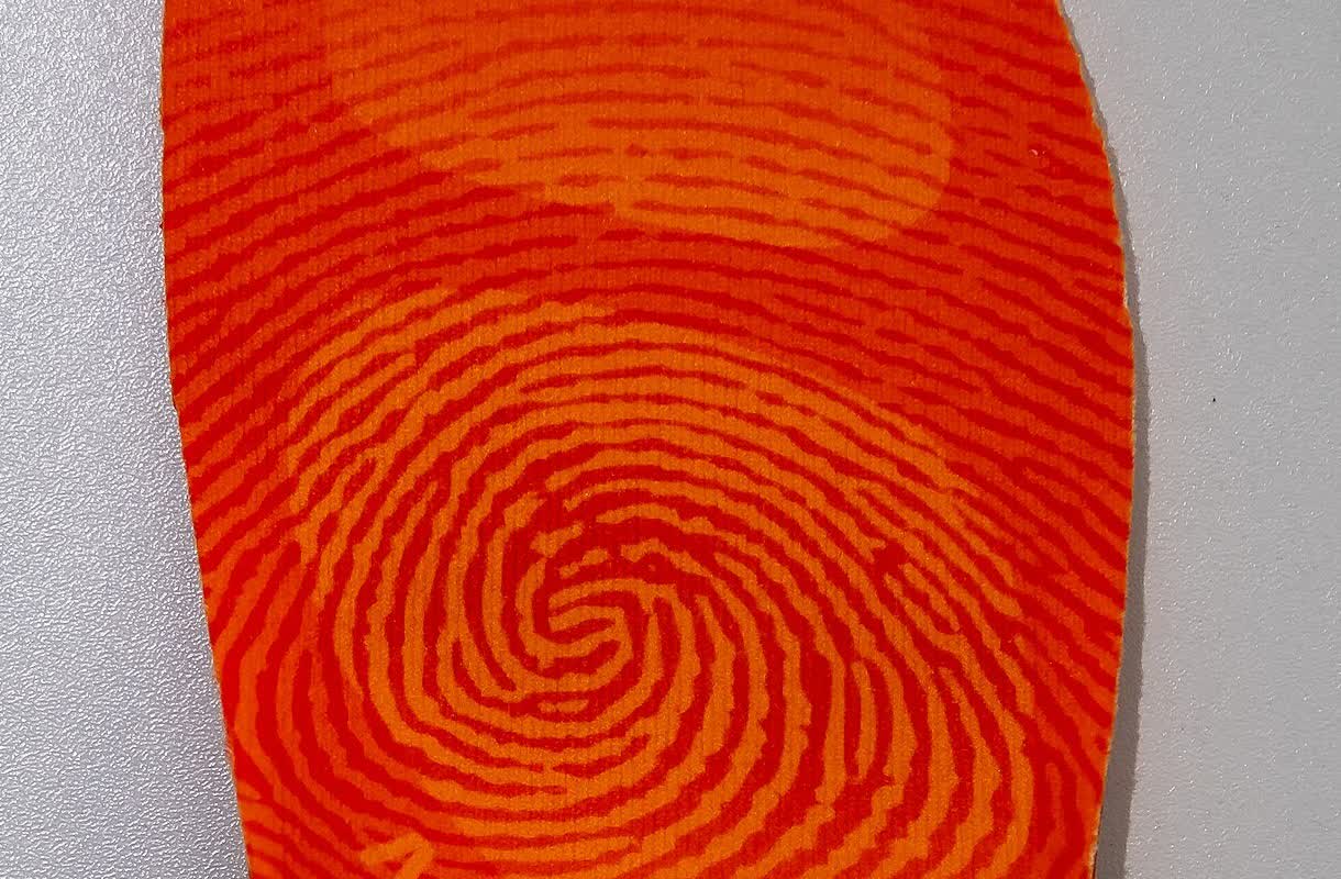 Aftermarket insole being fitted into a tennis shoe