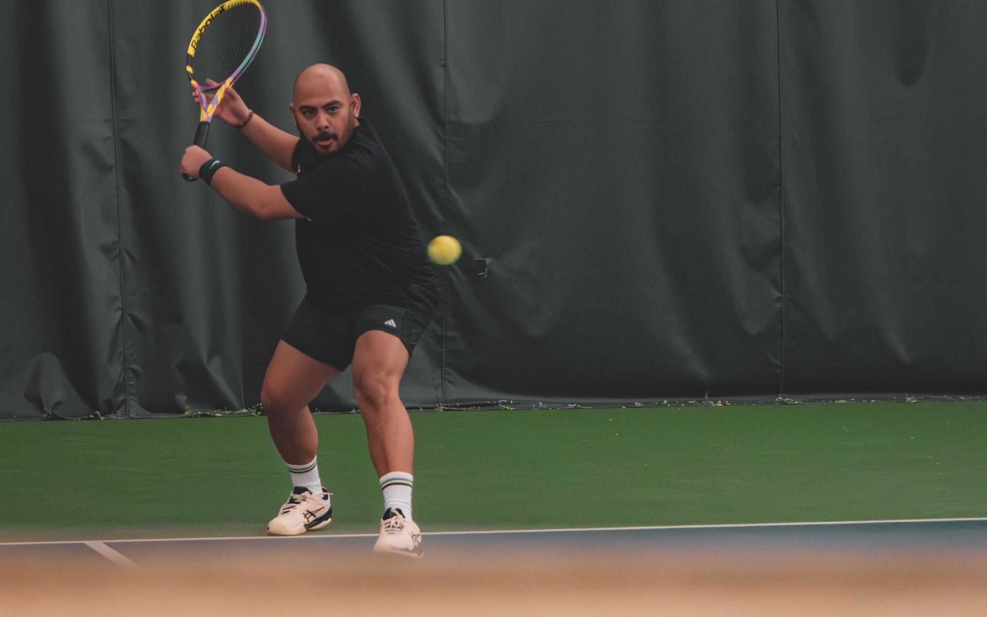 Tennis player with flat feet driving through a hard lateral cut on court