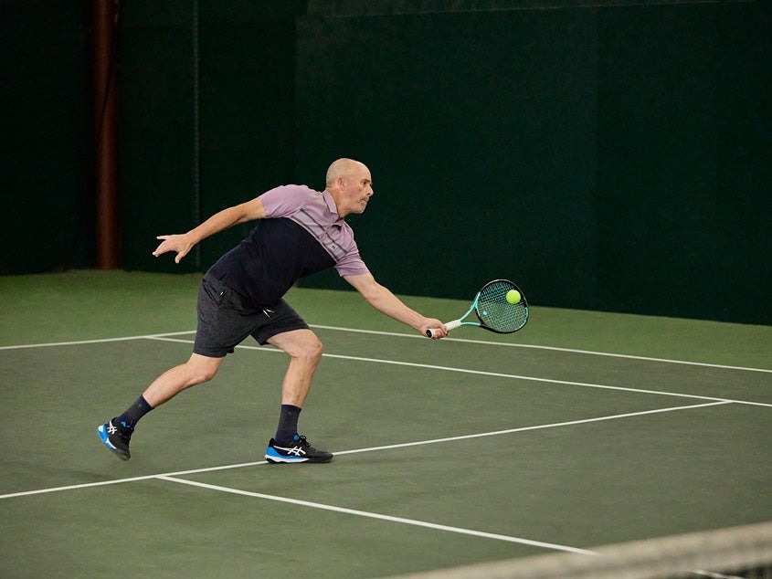 Player pushing off in supportive value tennis shoes