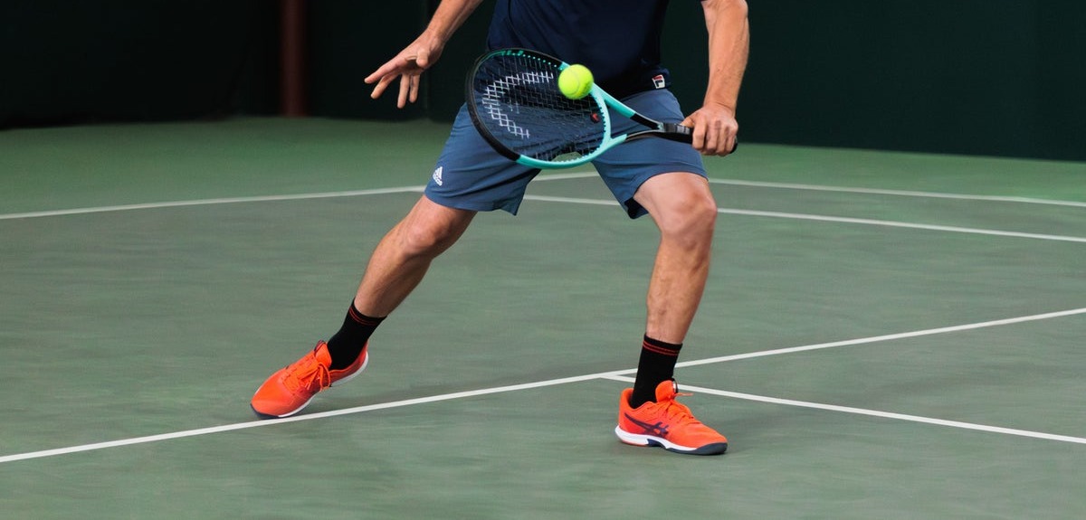Recreational player rallying in entry level tennis shoes