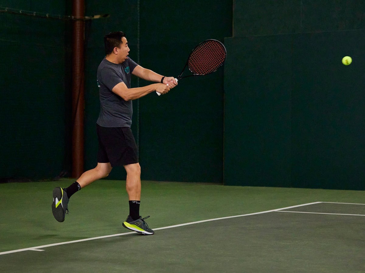Wide tennis shoes with a roomy toe box on a flat foot