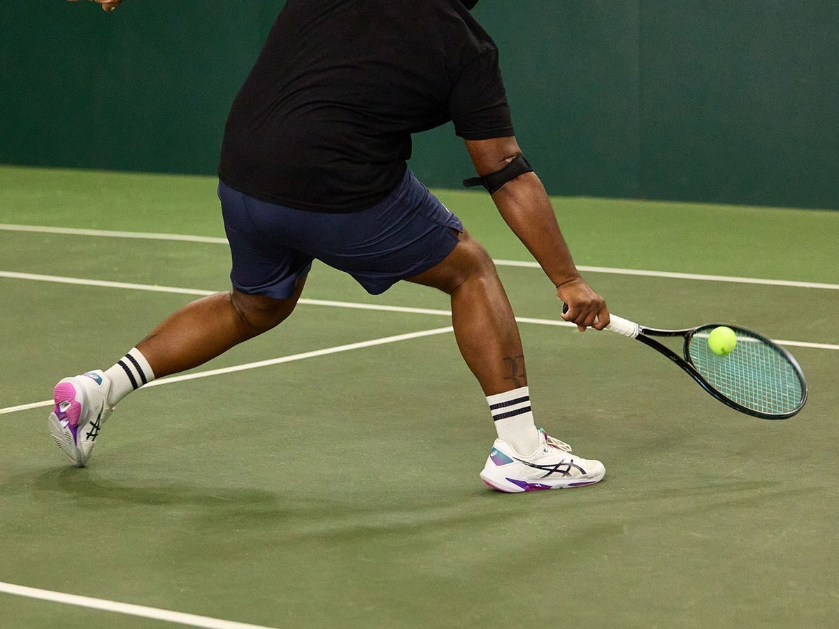Player sprinting forward in lightweight tennis shoes