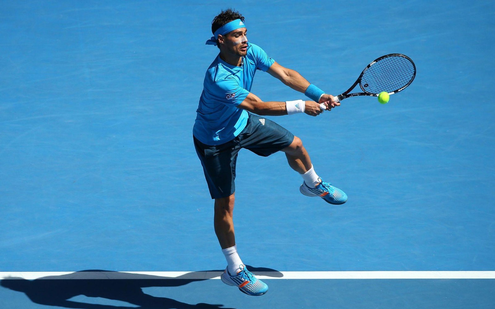 Tennis player on a blue hard court