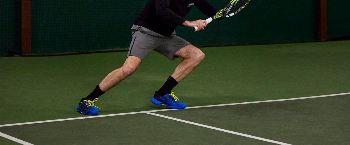 Player split-stepping in Babolat court shoes ready to move sideways